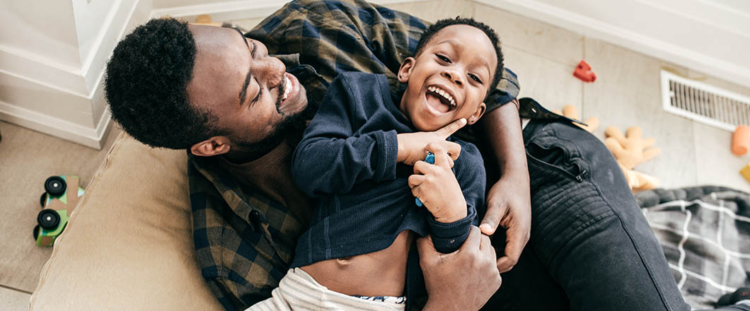 African American dad and son playing