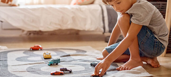 Shot of a little boy playing with his toys at home