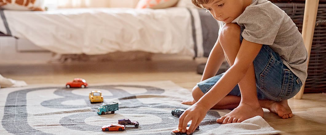 Shot of a little boy playing with his toys at home