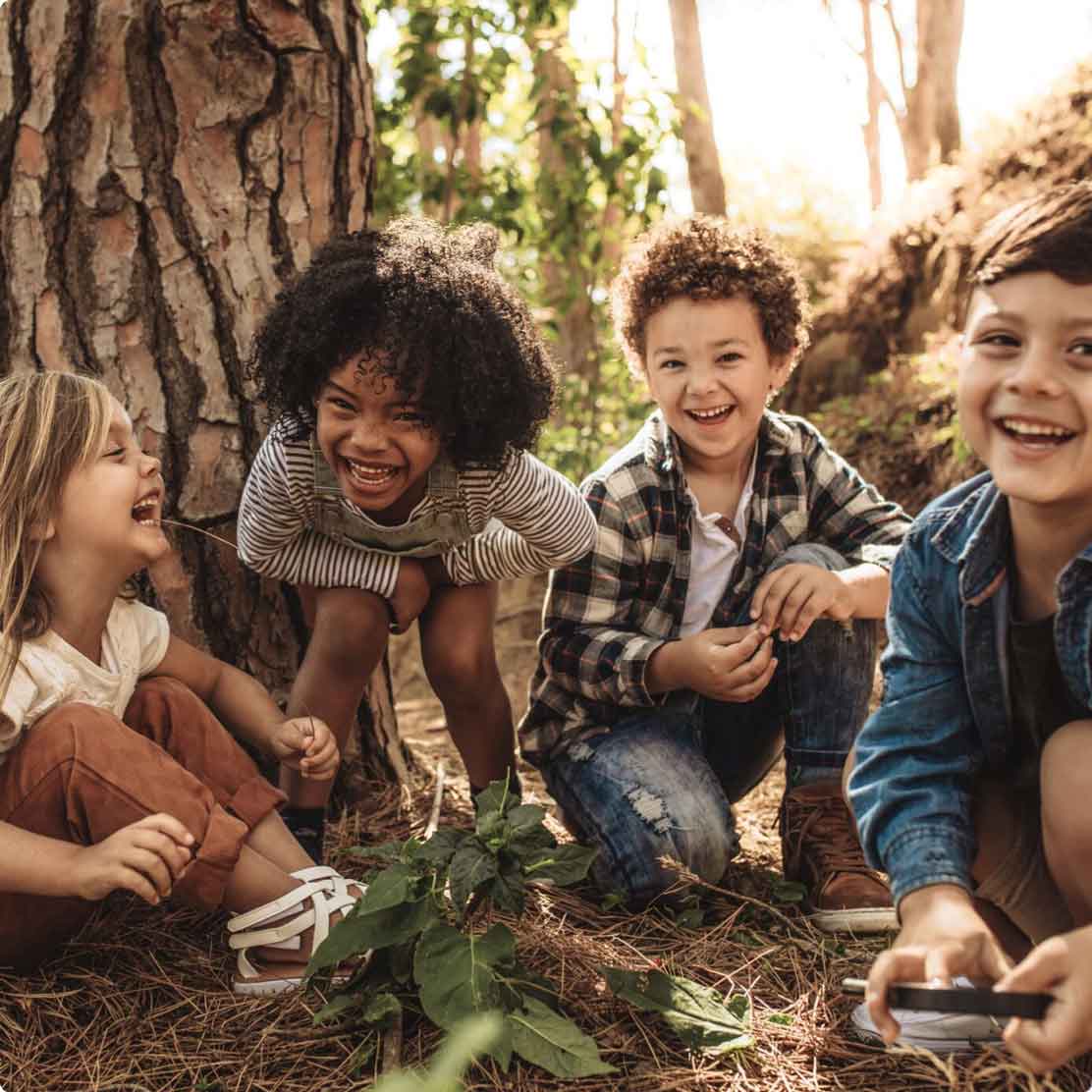 Children laughing and playing in the woods