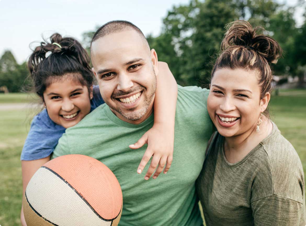 Family of three playing basketball