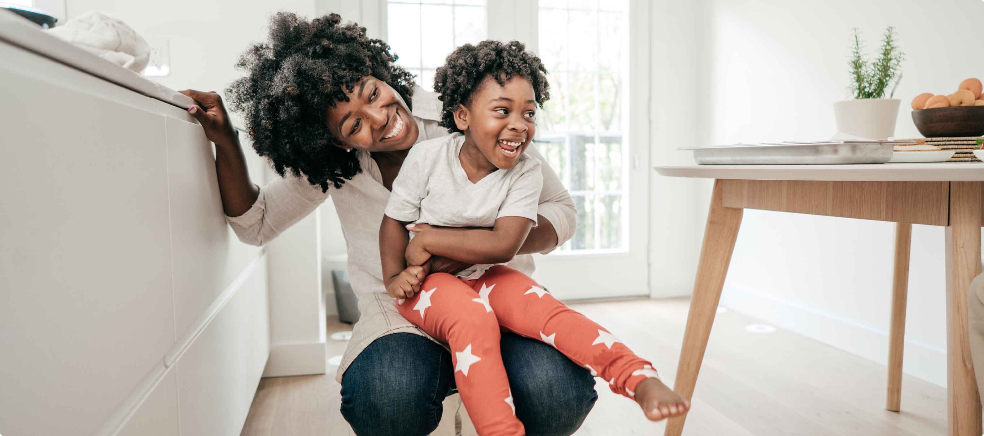 Affectionate African American mother and daughter playing