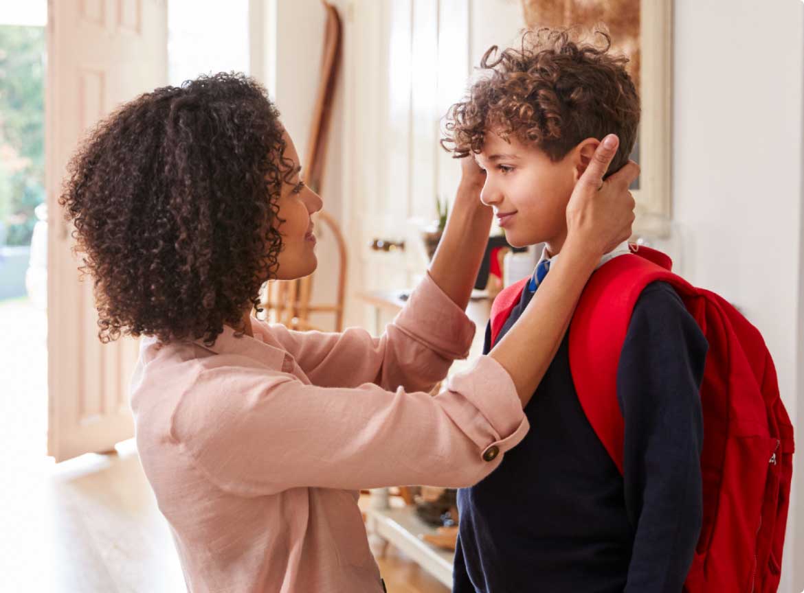 Mother helping her son get ready for school