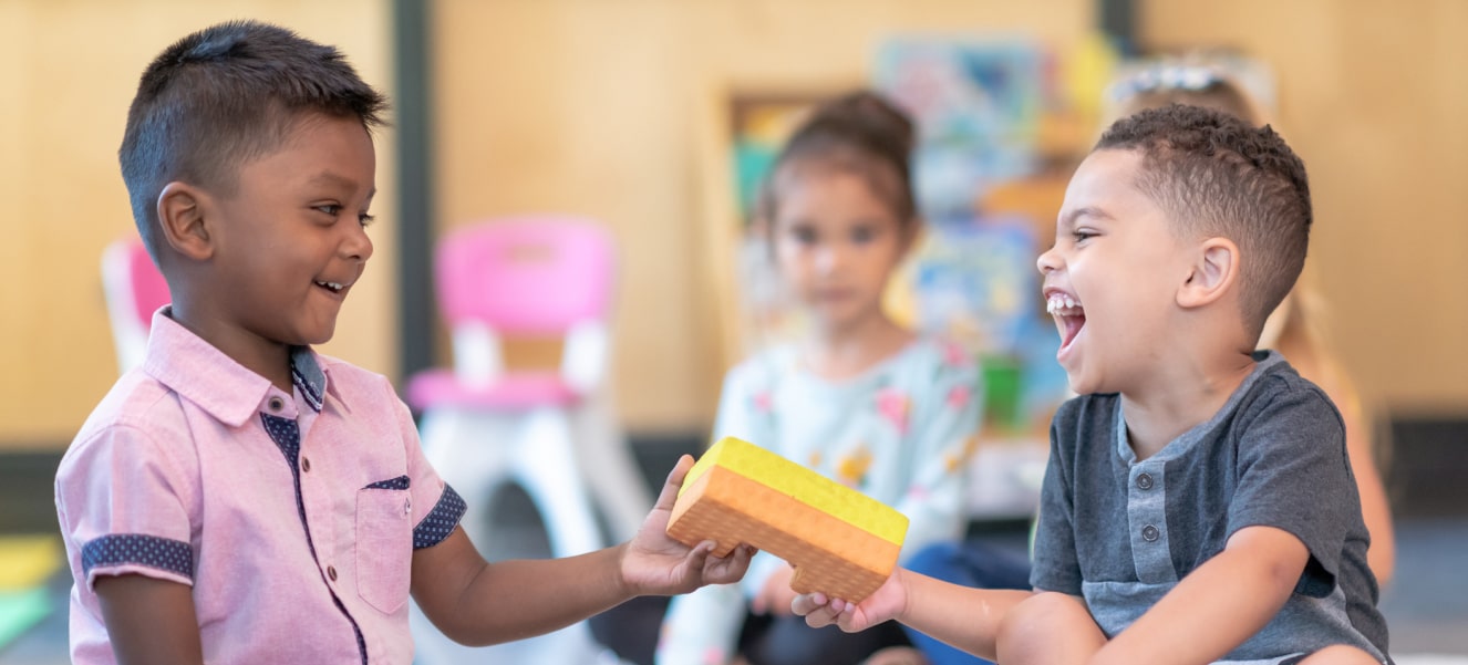 A child practicing daily living skills under the guidance of a therapist