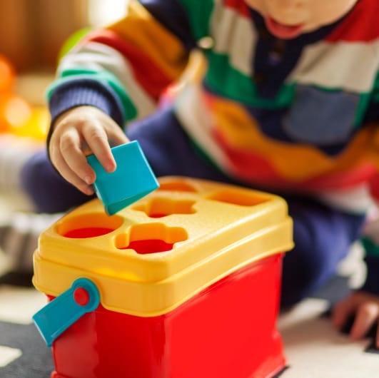 A child engaging in playful, structured activities in an ABA therapy center