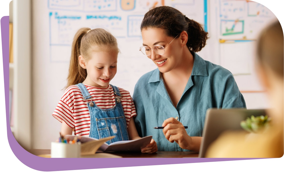 A child receiving ABA therapy in a school setting with a supportive therapist