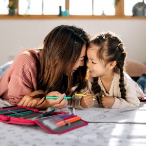 A child smiling with a therapist, highlighting Butterfly Effects' impactful approach.