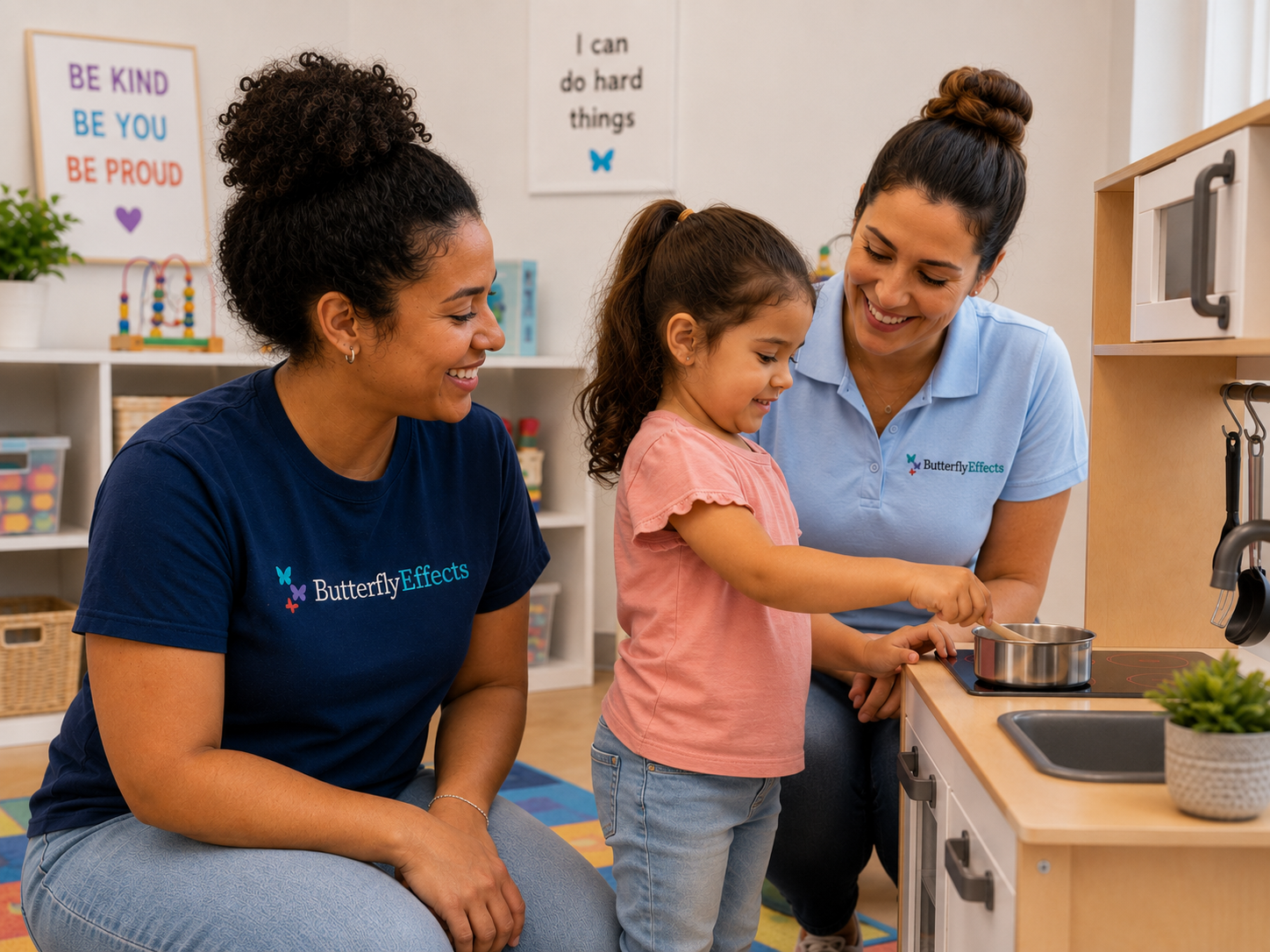 RBT working with young child at play kitchen while BCBA oversees